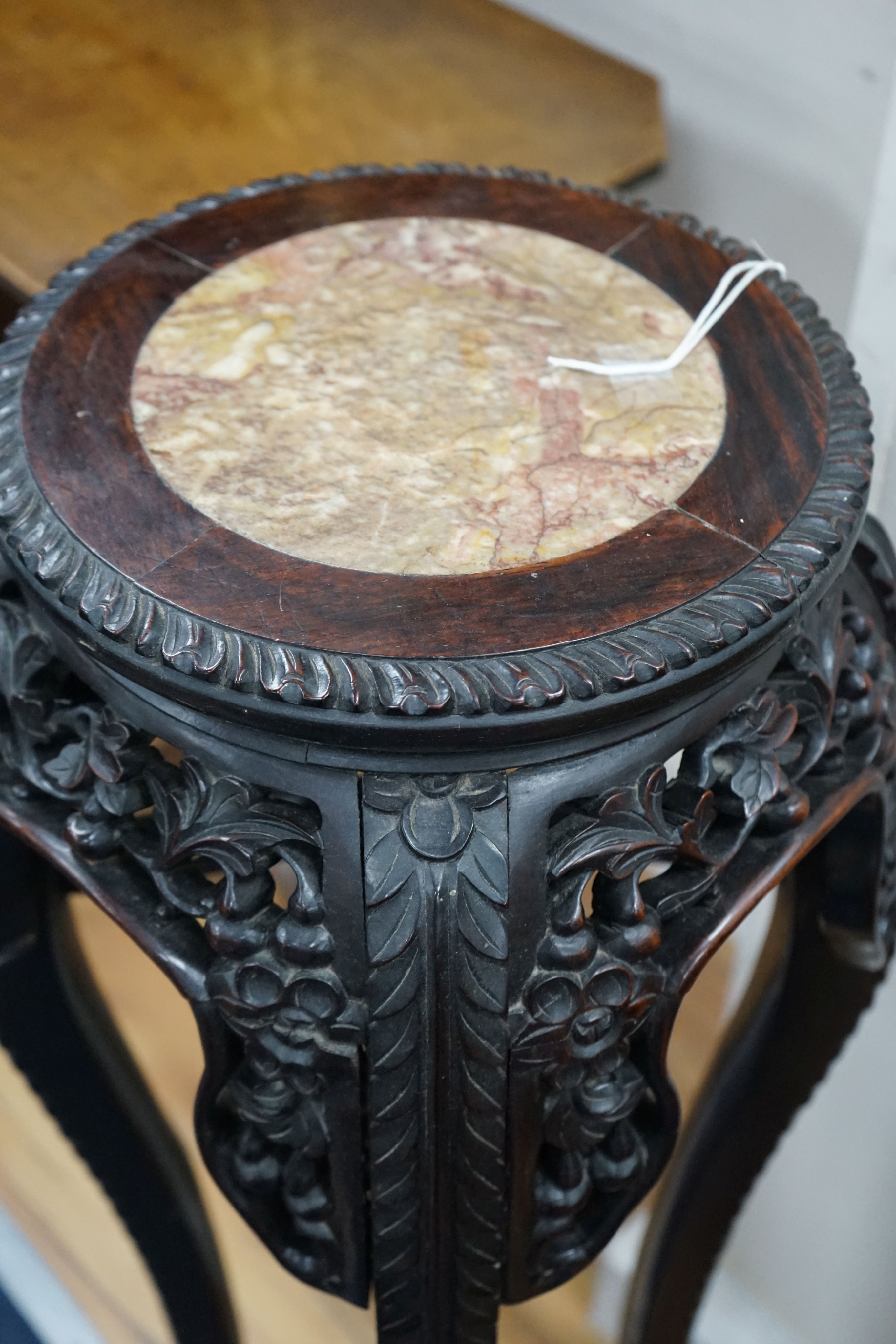 A Chinese circular marble top carved padouk jardiniere stand, height 91cm